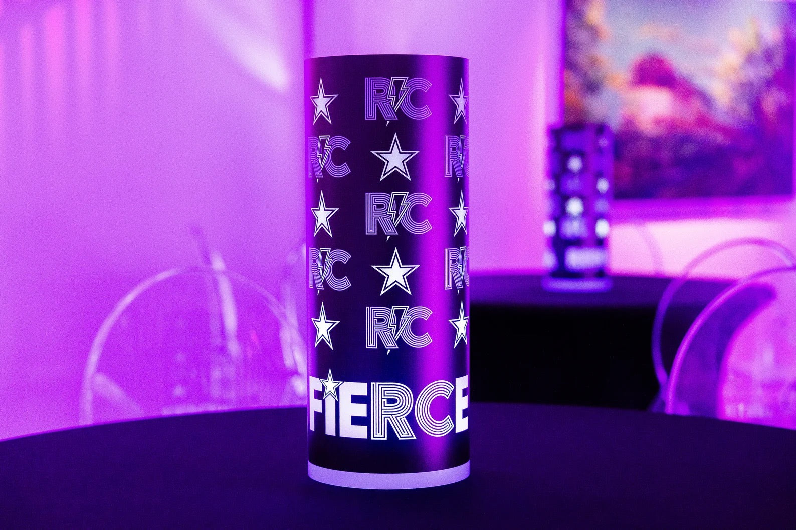 Purple tumbler with 'Fierce' text and star designs on a dark surface with a purple background