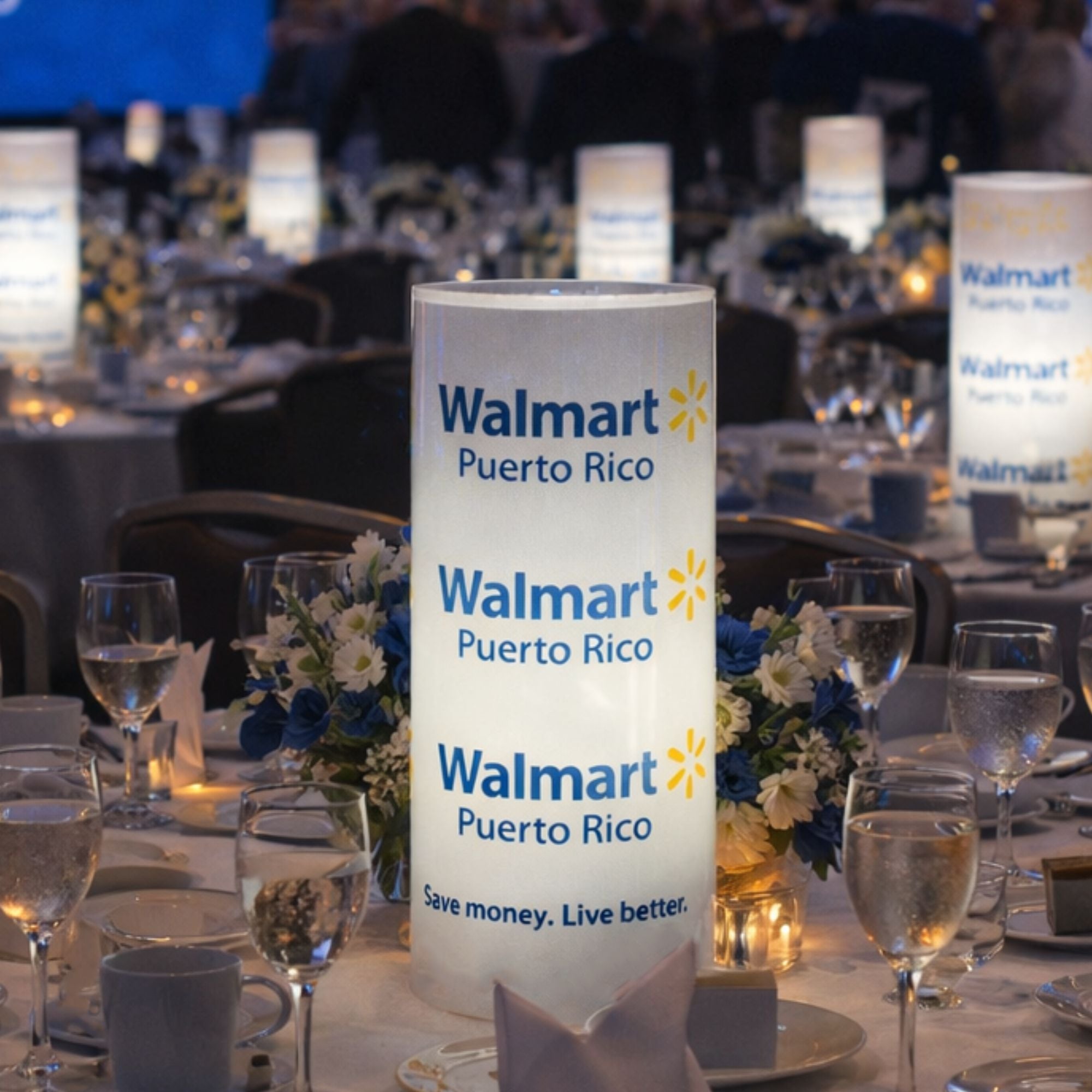 Walmart Puerto Rico sign on a table with wine glasses and floral arrangements