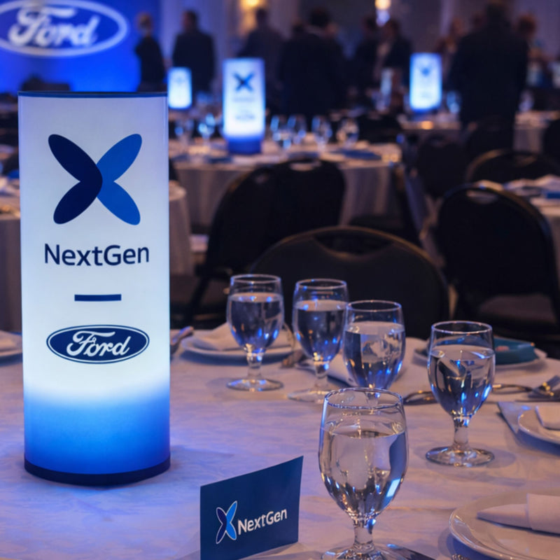 Table setting with Ford NextGen branding at an event.